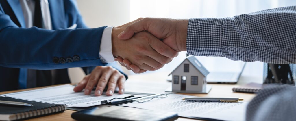 Young,Businessman,And,Financial,Representative,Shaking,Hands,After,A,Budget